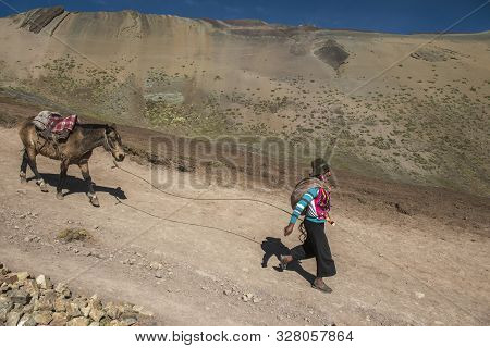 Vinicunca, Cusipata, Peru - June 08, 2017: Peruvian Andean Man Wearing Traditional Colorful Clothing