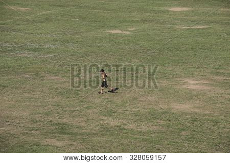 Vitória, Espírito Santo, Brazil - April 13, 2016:  Man Jogging In The Open Fields Of An Urban Park D