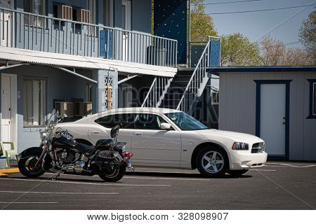 California, Usa. May 2010: Harley Davidson Bike And Fod Mustang Parked Outside A Road Motel