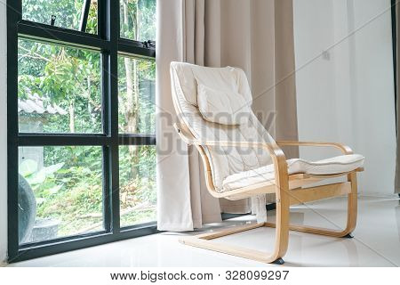 Wooden Armchair Sofa In Modern Room With Curtain On Glass Wondow
