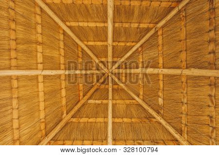 Close Up Shot Of The Inside Of A Thatched Reet Roof With Cross Beam Enforcements. Use For Background