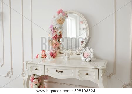 Vintage Style Boudoir Table With Round Mirror And Flowers. White Bright Room.