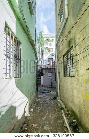Corridor Of Street Between Two Small Buildings