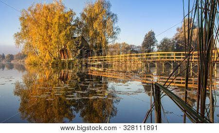 Morning Landscape, Wooden Hunting Lodge, On A Small Man-made Island. A Wooden Platform Is Coming To 