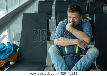 Young Man At The Airport Waiting For His Plane Looking At The Windoe