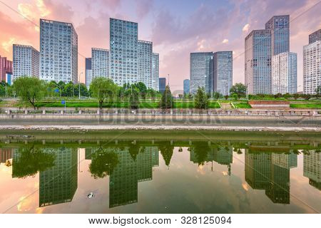 Beijing, China CBD city skyline and canal at night.