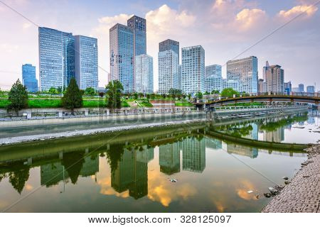 Beijing, China CBD city skyline and canal at night.
