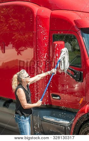 Woman Truck Driver Washing Semi-truck While She Waits For Her D.o.t. 70 Hour Reset.