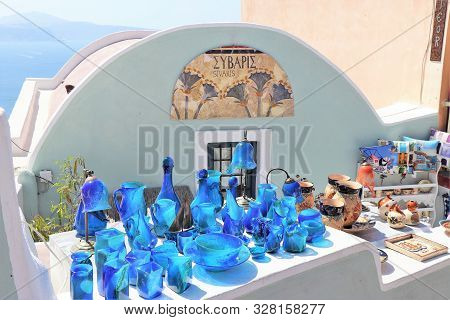 Santorini, Greece, Europe - 8/4/2019 - Glassware And Souveneirs For Sale At A Market In Santorini, G