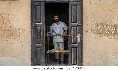 Masuleh, Iran - May 2019: Man Working At Local Bakery Selling Bread
