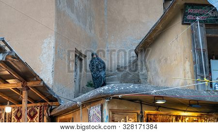 Masuleh, Iran - May 2019: Iranian Old Woman Walking Down The Stairs In The Narrow Road Of Masuleh Vi