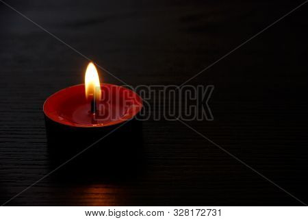 Red candle burning. Red candle burning on black background for background pictures