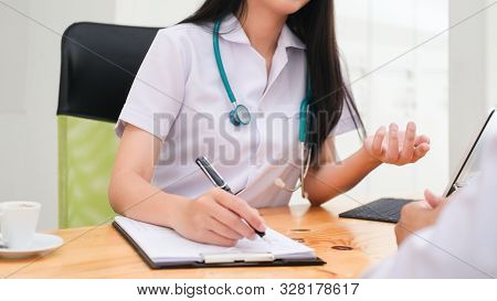 Doctor Giving Medical Advice To Patient.