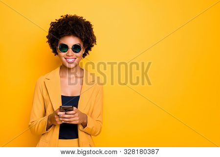 Portrait Of Positive Cheerful Afro American Girl In Sunglass Use Her Smartphone Type Text Post Comme