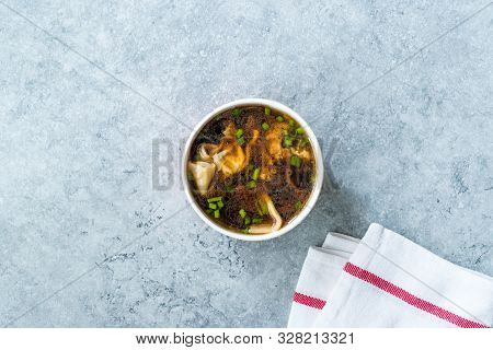 Take Away Asian Food Wonton Soup With Bok Choy And Chives In Plastic Bowl Package Or Container Box.