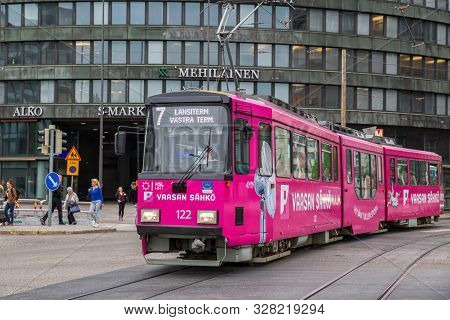 Helsinki, Finland - May 23, 2019: Bright Pink Tram Of Route 7 Near Mehiläinen Helsinki Circle House
