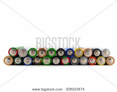 Old Aa Batteries Of Different Colors Are Stacked On Top Of Each Other. Batteries On White Background