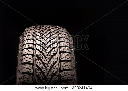 New Directional Friction Winter Tire Velcro Without Spikes On Black Background. Rubber For Ice Water