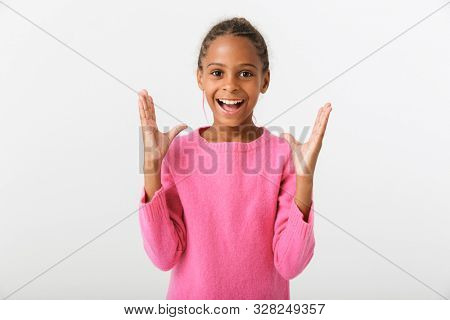 Image of african american excited girl smiling and posing with trowing up hands isolated over white background