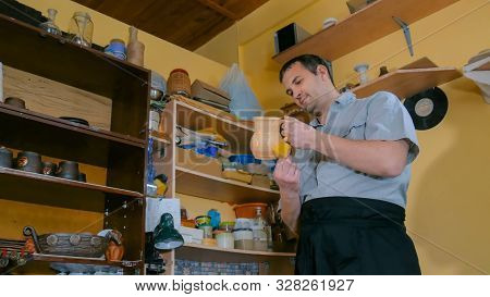 Professional Male Potter Preparing Ceramic Wares For Burning In Pottery Kiln With Milk - Old Russian