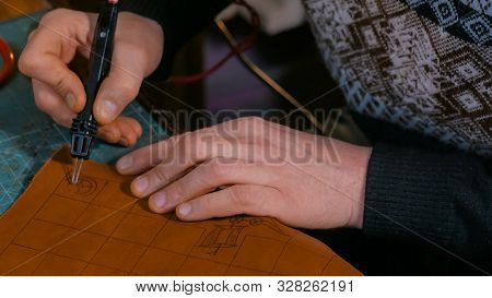 Professional Male Skinner, Tanner Making Decorative Details On Leather Playing Field For Strategy Bo