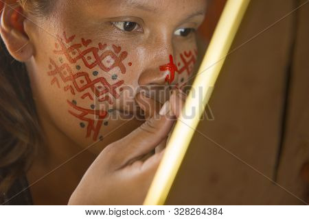 Manaus, Amazonas, Brazil - August 16, 2016: Indigenous Woman Painting Her Face At Dessana Village, A