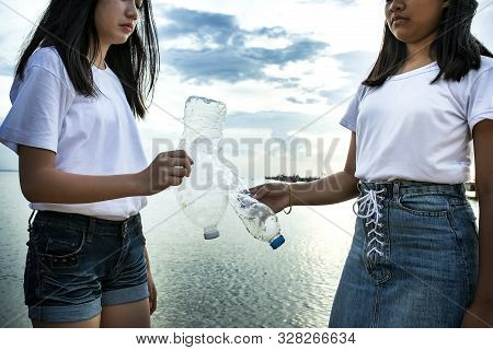Two Asian Teenager Holding Old Waste Plastic Bottle Standing On Sea Beach For Ocean Environmental Is