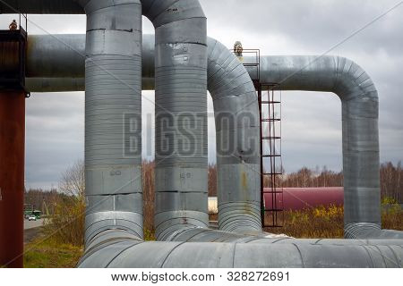 Modern Elevated Heat Pipes. Pipeline Above Ground, Conducting Heat To Heat City. Urban Line In Metal