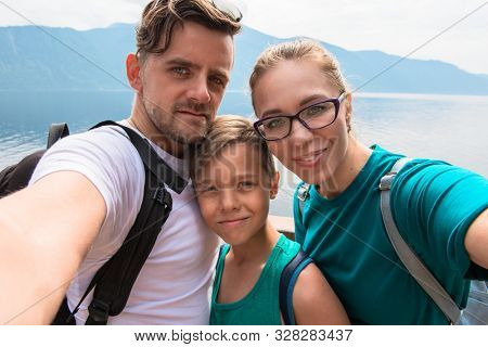Selfie of family on the Teletskoye lake in Altai mountains, Siberia, Russia. Beauty summer day.