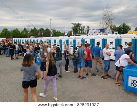 Katowice, Poland - August 10, 2019: People Visit Massive Portable Restroom Array At A Music Event Me