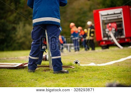 Germany, Niederstetten, Baden Wurttemberg. September 2019 Young Firefighters In Training, Pumping Wa