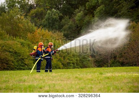 Germany, Niederstetten, Baden Wurttemberg. September 2019 Young Firefighters In Training With Fire H
