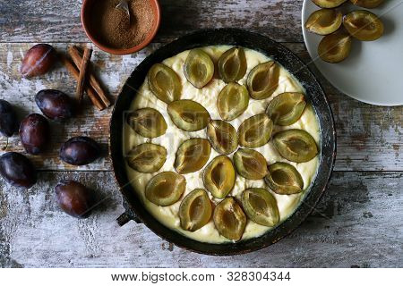 Making Plum Pie With Sugar And Cinnamon. American Plum Pie.