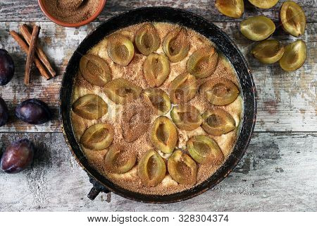 Making Plum Pie With Sugar And Cinnamon. American Plum Pie.