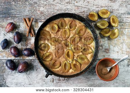Making Plum Pie With Sugar And Cinnamon. American Plum Pie.