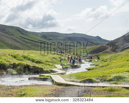 Iceland, Hveragerdi, August 5, 2019: Crowded Natural Geothermal Bath In A Hot River Stream In Reykja