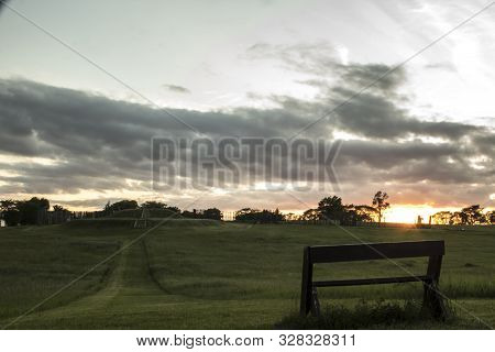 Bench Overlooking The Sunset And Indian Mound At Aztalan State Park Near Lake Mills, Wisconsin
