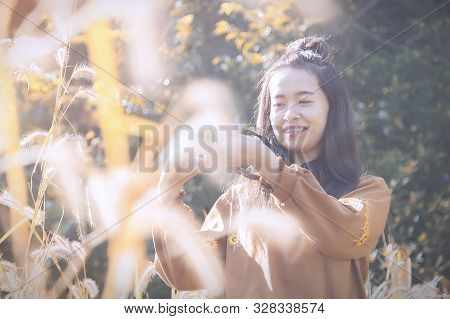 Portrait Of Beautiful Asian Girl Are Taking Photo By Campact Camera In The Garden With Sunrise.