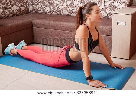 Close Up Portrait Of Young Smiling Woman Doing Exercises On Blue Mat At Home. Pretty Girl Training I