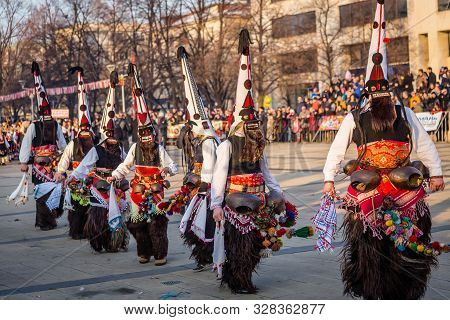 Mummers perform rituals to scare evil spirits at Surva festival at Pernik in Bulgaria. The people with the masks are called Kuker (kukeri). Dancers with big bells.