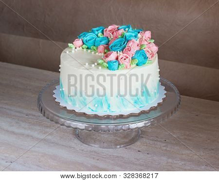 Gorgeous Cake Covered In Bright Roses Made Of Butter Cream Icing On Light Wooden Background