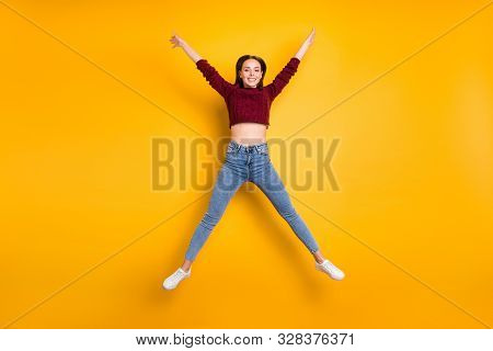 Fulll Body Photo Of Charming Lady Raising Her Arms Wearing Maroon Pullover Isolated Over Yellow Back