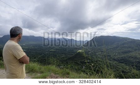 Hiker At The Top Of India Dormida Mountain Overlooking The Town Of El Valle De Anton, Panama