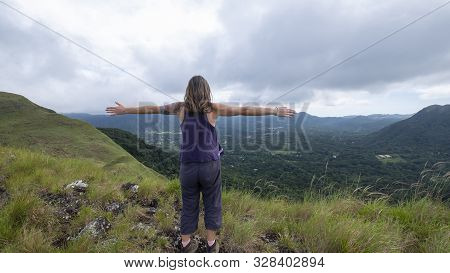 Woman Hiker With Open Arms On Top Of India Dormida Mountain At El Valle De Aton, Panama