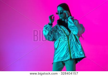 Young Stylish Girl Dancing In The Studio On A Colored Neon Background. Music Poster Design.