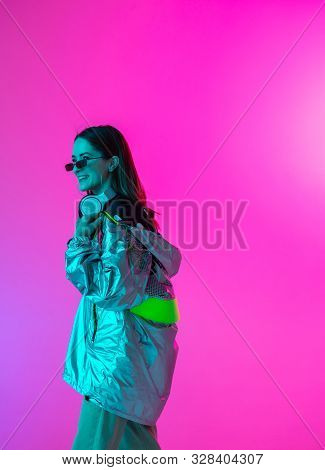 Young Stylish Girl Dancing In The Studio On A Colored Neon Background. Music Poster Design.