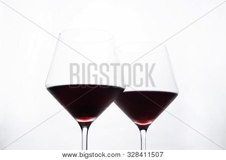 A Glasses Of Red Wine Close-up On A Light Background. Minimalism. Copy Space. The Concept Of Tasting