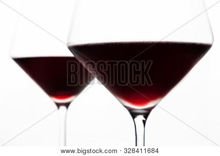 A Glasses Of Red Wine Close-up On A Light Background. Minimalism. Copy Space. The Concept Of Tasting