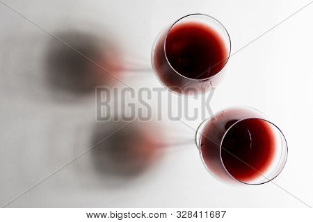 A Glasses Of Red Wine Close-up On A Light Background. Minimalism. Copy Space. The Concept Of Tasting
