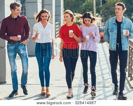 Teens Leisure. Social Communication Fun. Group Of Male Female Friends Walking With Take Away Coffee.